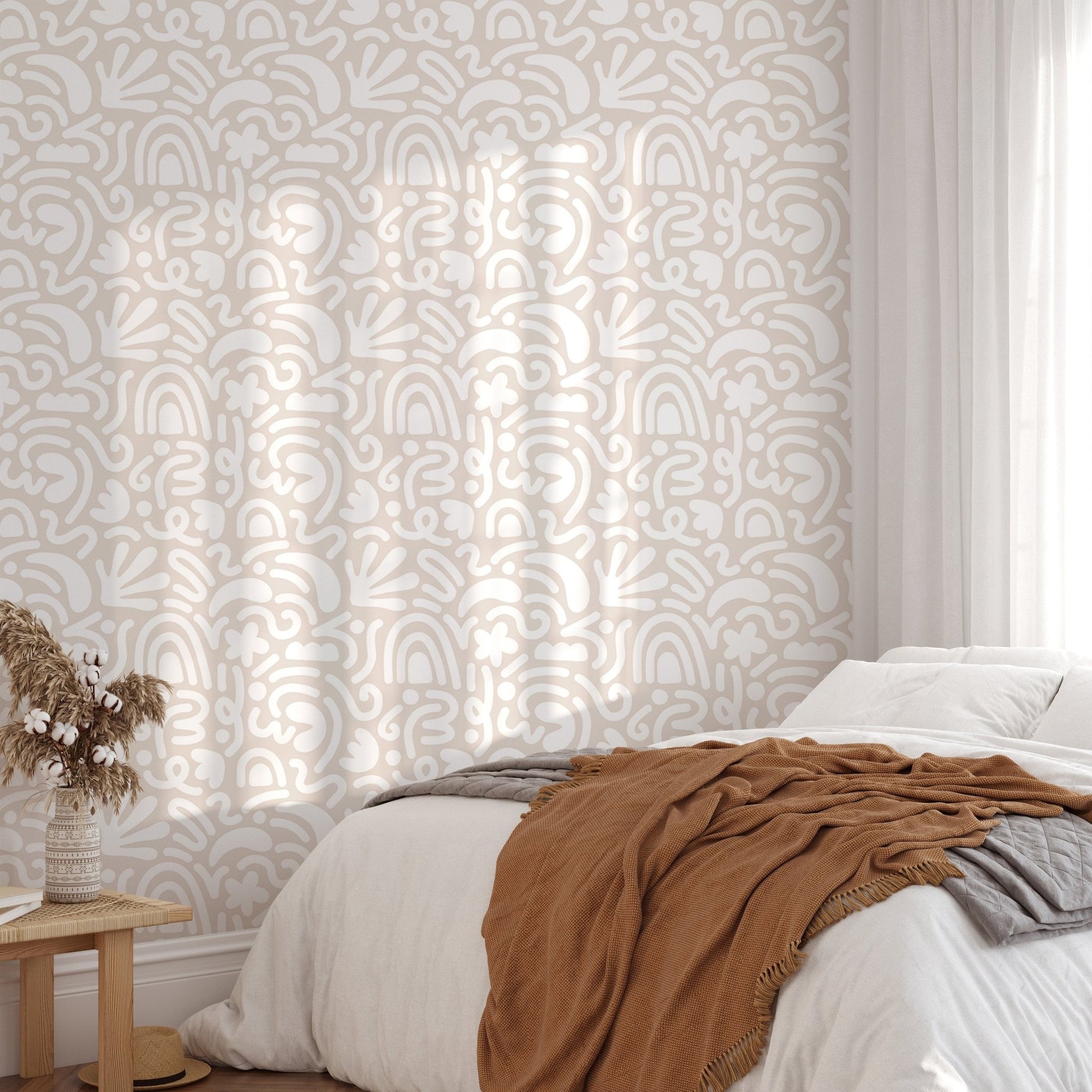 Scandinavian wallpaper in a bright bedroom with a brown throw blanket.