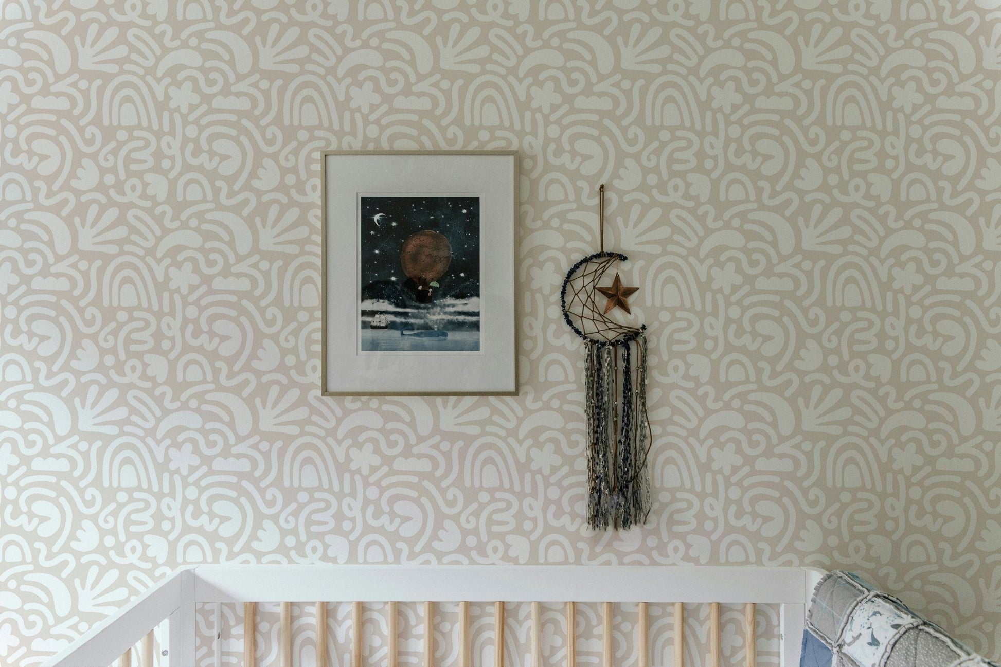 Abstract Wallpaper in a nursery setting featuring a framed picture and white crib.
