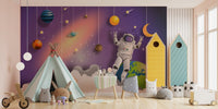 Outer space mural with astronauts, stars, and galaxies for playroom walls.
