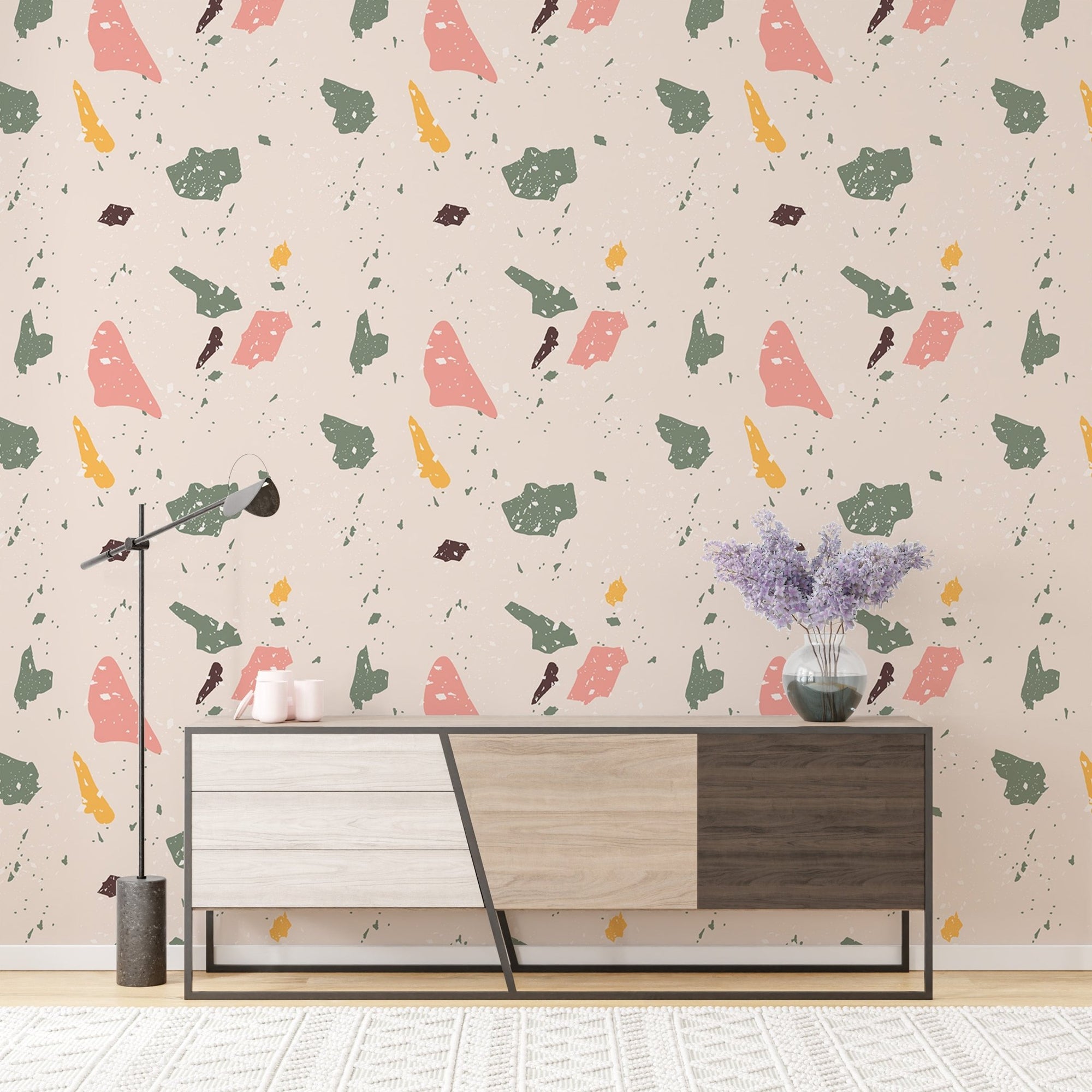 Multi-colored granite pattern wallpaper behind a modern grey and brown sideboard.