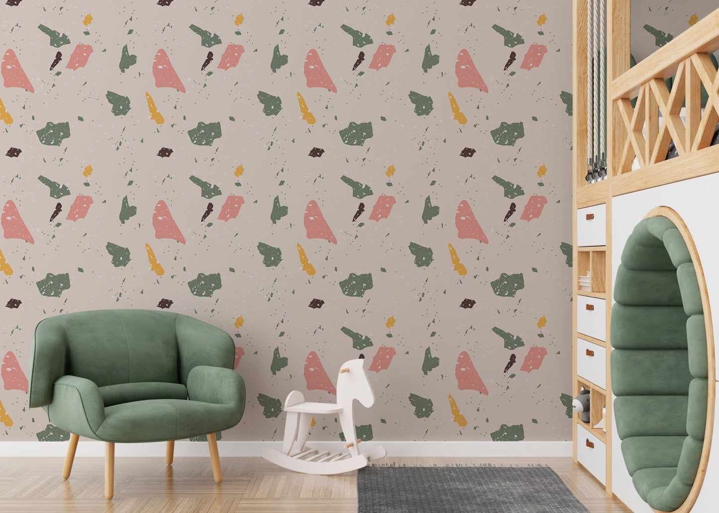 Terrazzo pattern wallpaper in a kids' play area with a green armchair and toy horse.