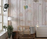Subtle tree branch wall mural in a nursery with a wooden crib.