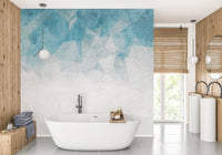 Bathroom wall mural with blue abstract patterns behind a freestanding tub.