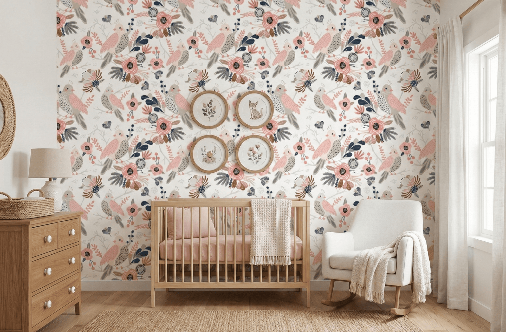 Floral bird wallpaper in baby room with grey nursing chair and wooden dresser.