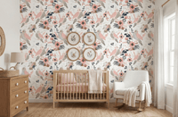 Floral bird wallpaper in baby room with grey nursing chair and wooden dresser.