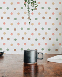 Coffee mug on a dark table with blurred polka dot wallpaper in the background.