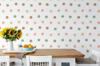 Dining space with a white table and large scale watercolor dot wallpaper.