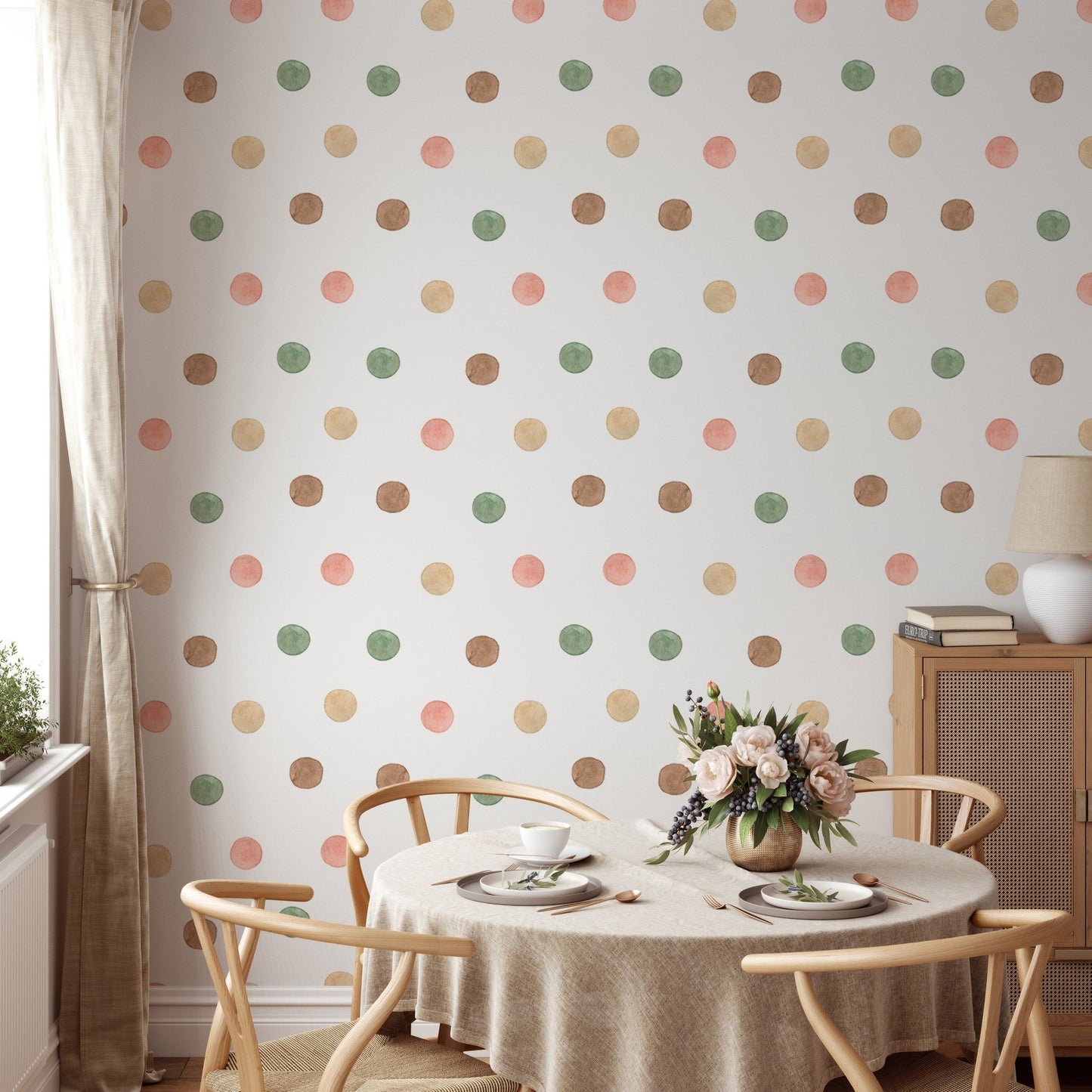 Round dining table set against a soft watercolor polka dot wallpaper.