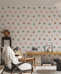 Boho style living interior with a black chair and multi-color dot wallpaper.