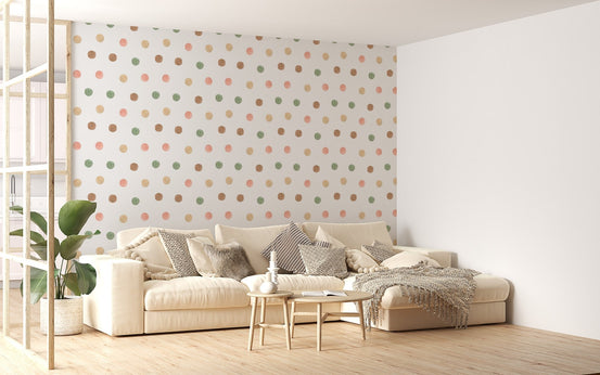 Modern living room with a beige sofa and boho style watercolor dot wallpaper.