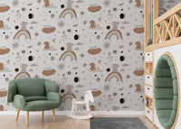 Earth tone rainbow design wallpaper in a modern nursery with a green armchair.