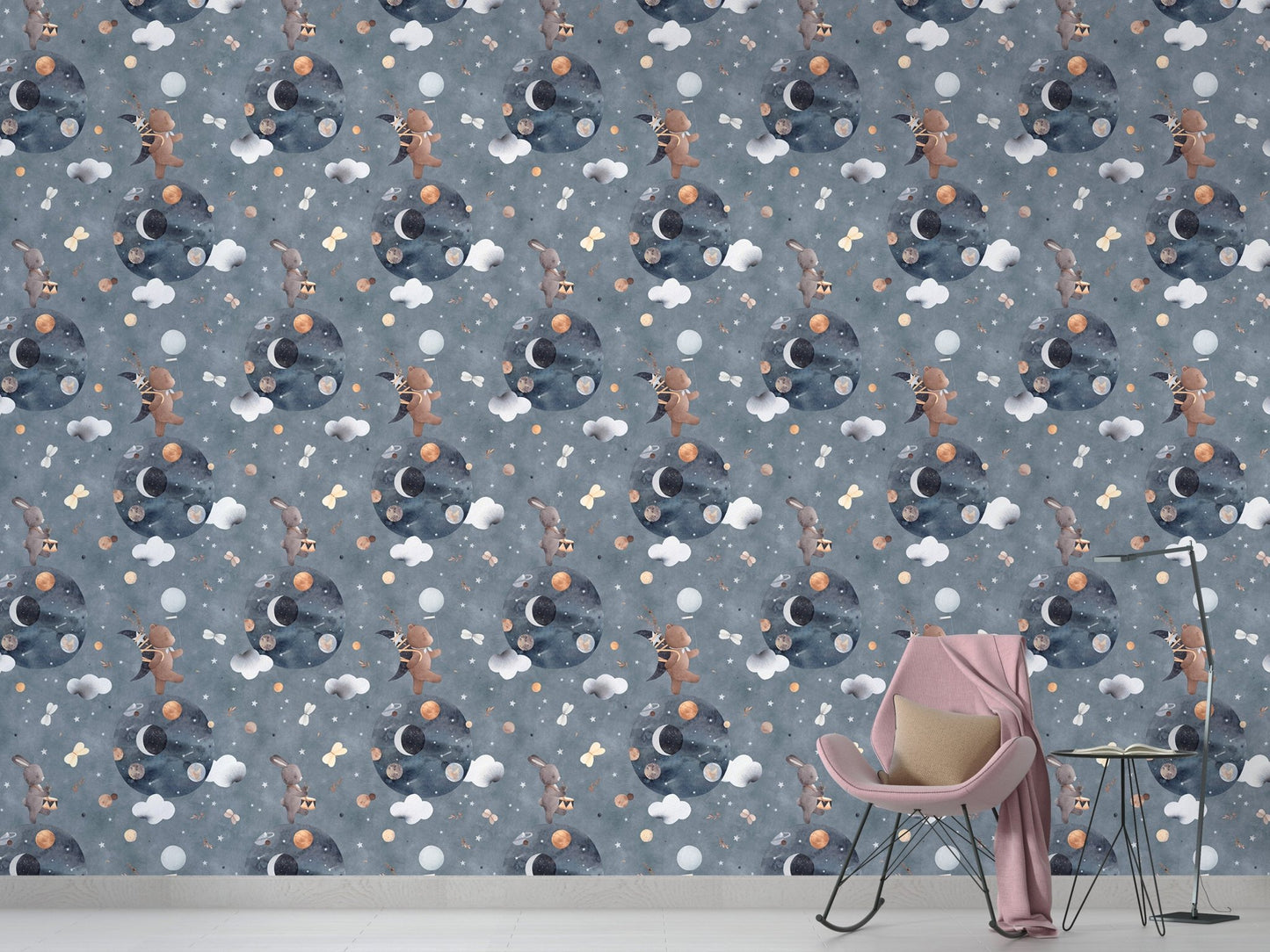 Grey and blue space themed wallpaper behind a pink rocking chair in a playroom.