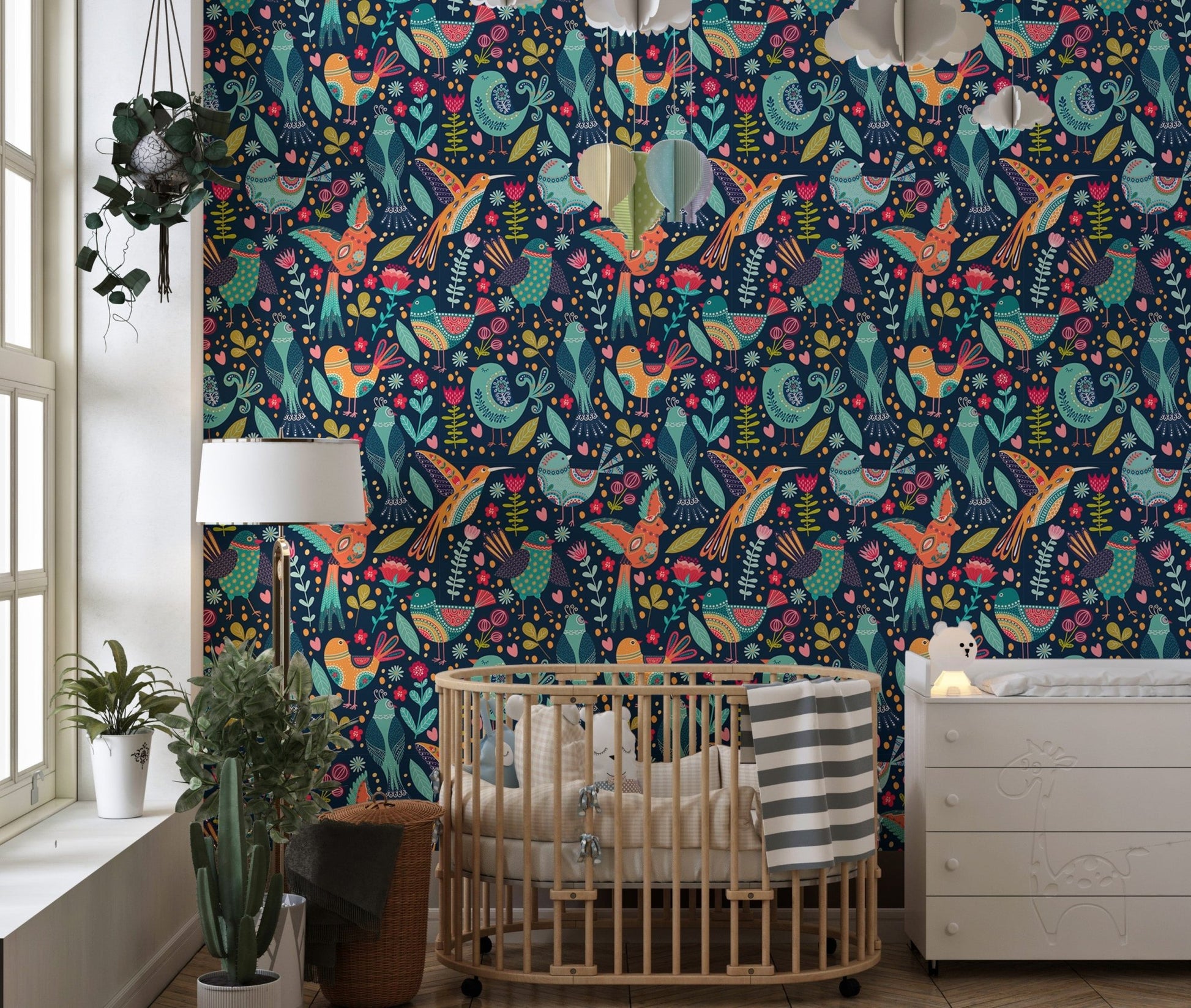 Folk style bird wallpaper in a child's room with a small wooden bed.