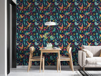 Bright folk art wallpaper in a dining room with wooden table and chairs.