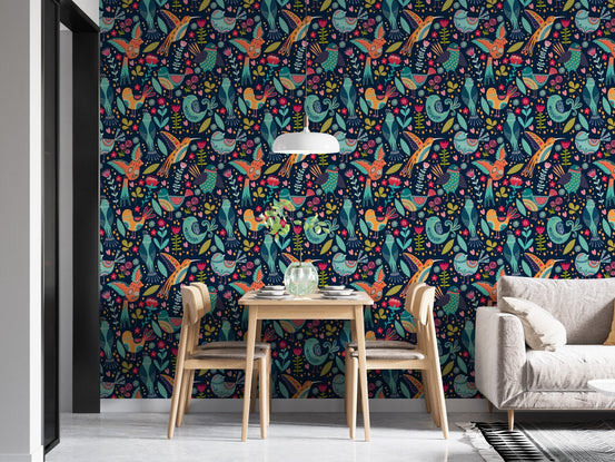 Bright folk art wallpaper in a dining room with wooden table and chairs.