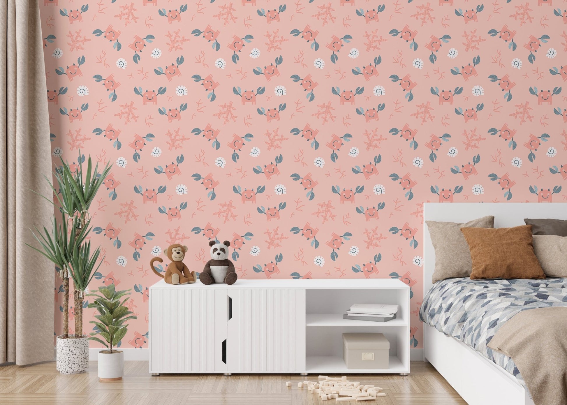 Crab and sea shell pattern wallpaper in a bedroom with a white storage unit.