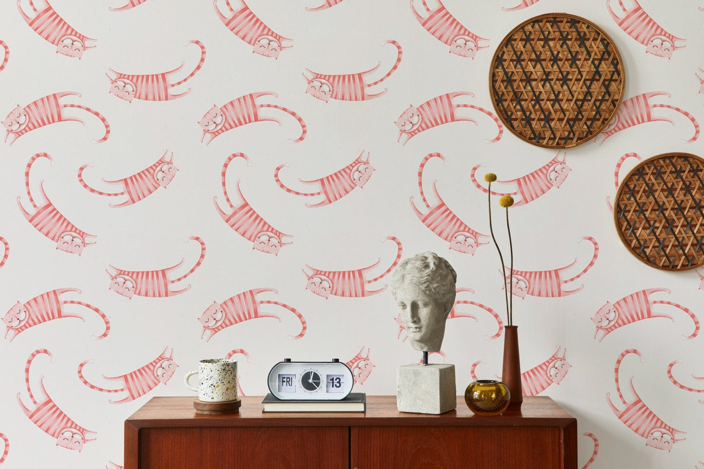 Living room wallpaper with pink striped cats and circular woven wall art.
