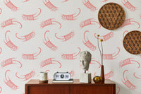 Living room wallpaper with pink striped cats and circular woven wall art.