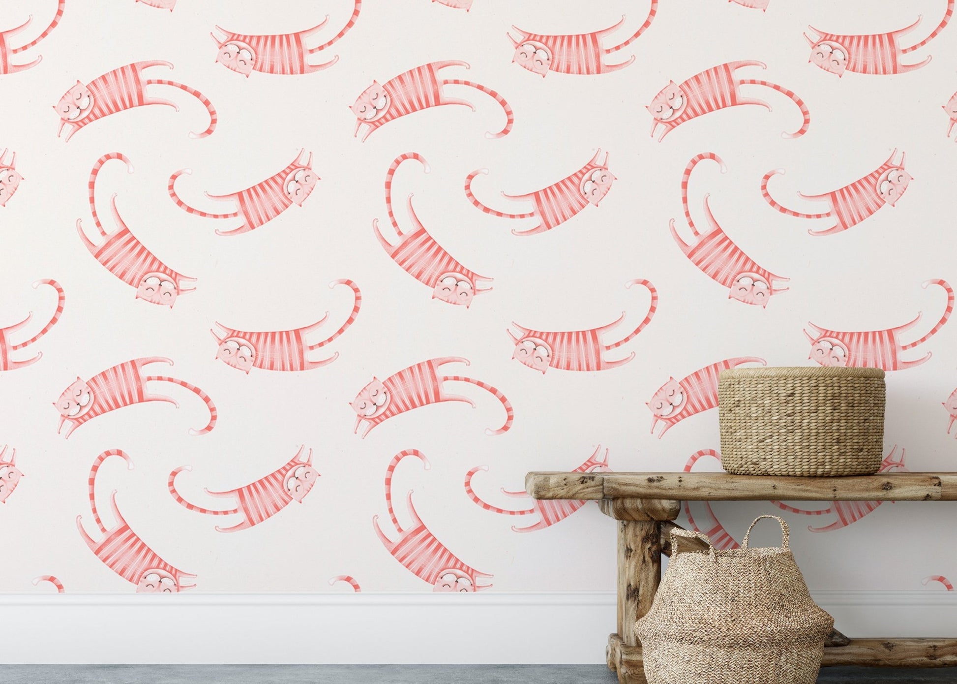 Pink striped cats wallpaper behind a rustic wooden bench and natural fiber baskets.
