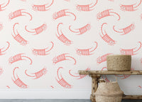 Pink striped cats wallpaper behind a rustic wooden bench and natural fiber baskets.