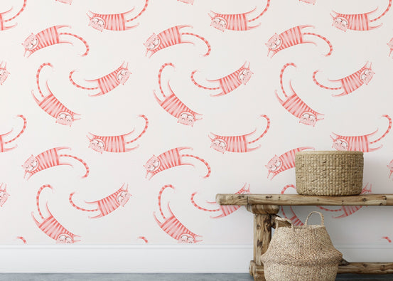 Pink striped cats wallpaper behind a rustic wooden bench and natural fiber baskets.