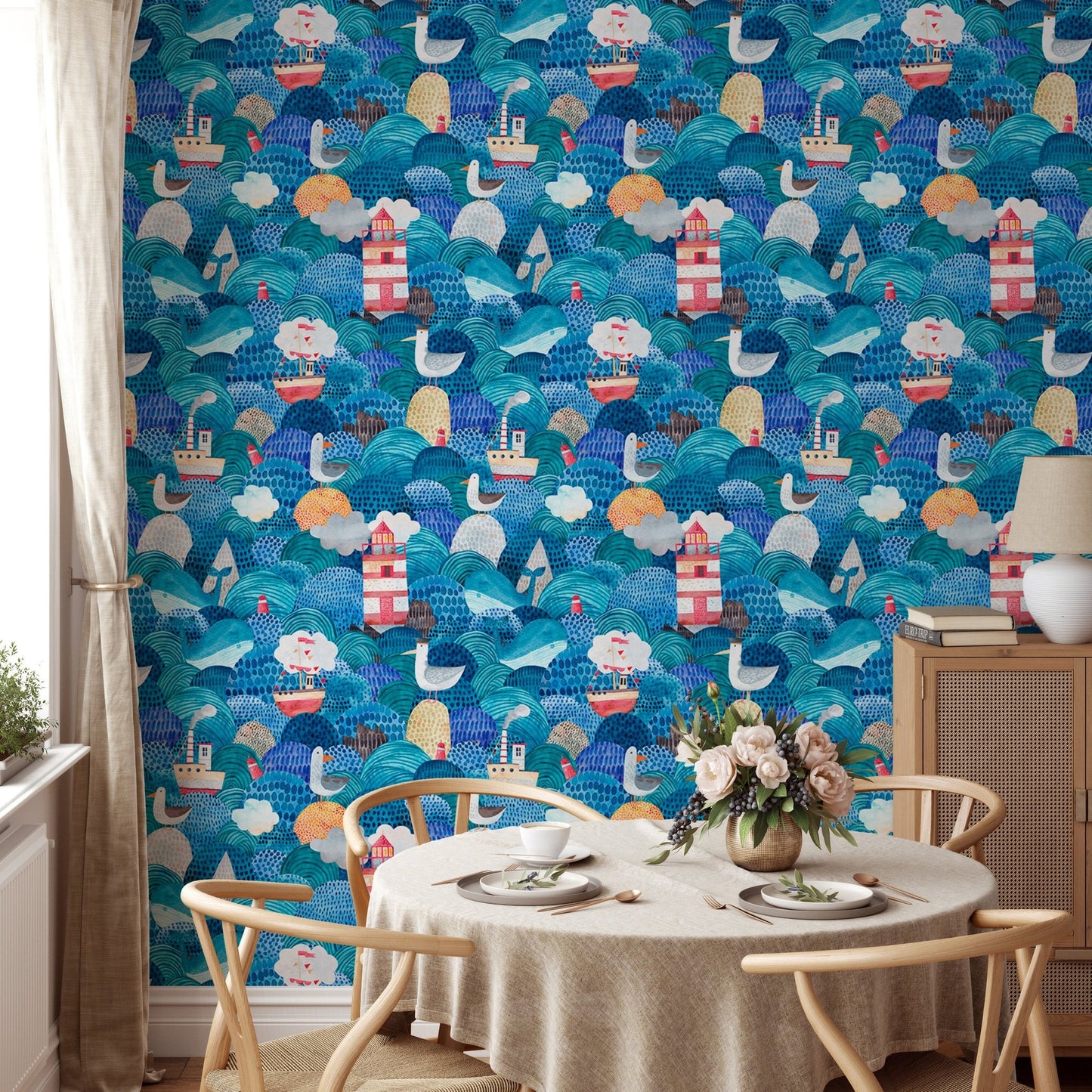 Round dining table with chairs and nautical themed blue wallpaper.