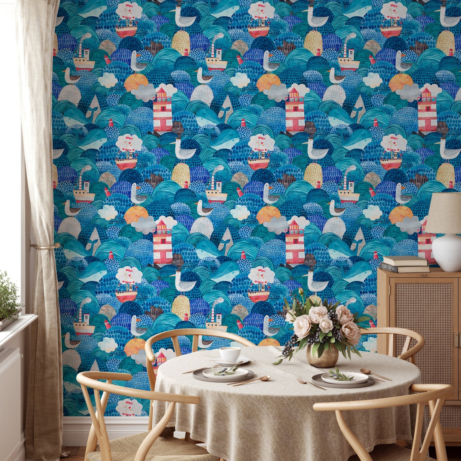 Round dining table with chairs and nautical themed blue wallpaper.