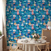 Round dining table with chairs and nautical themed blue wallpaper.