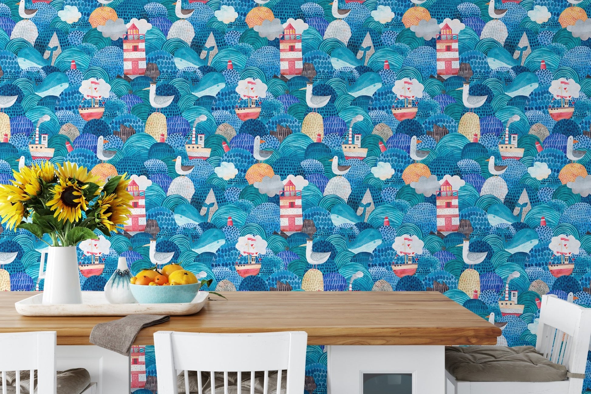 Dining room table set against a lighthouse and nautical ship wallpaper.