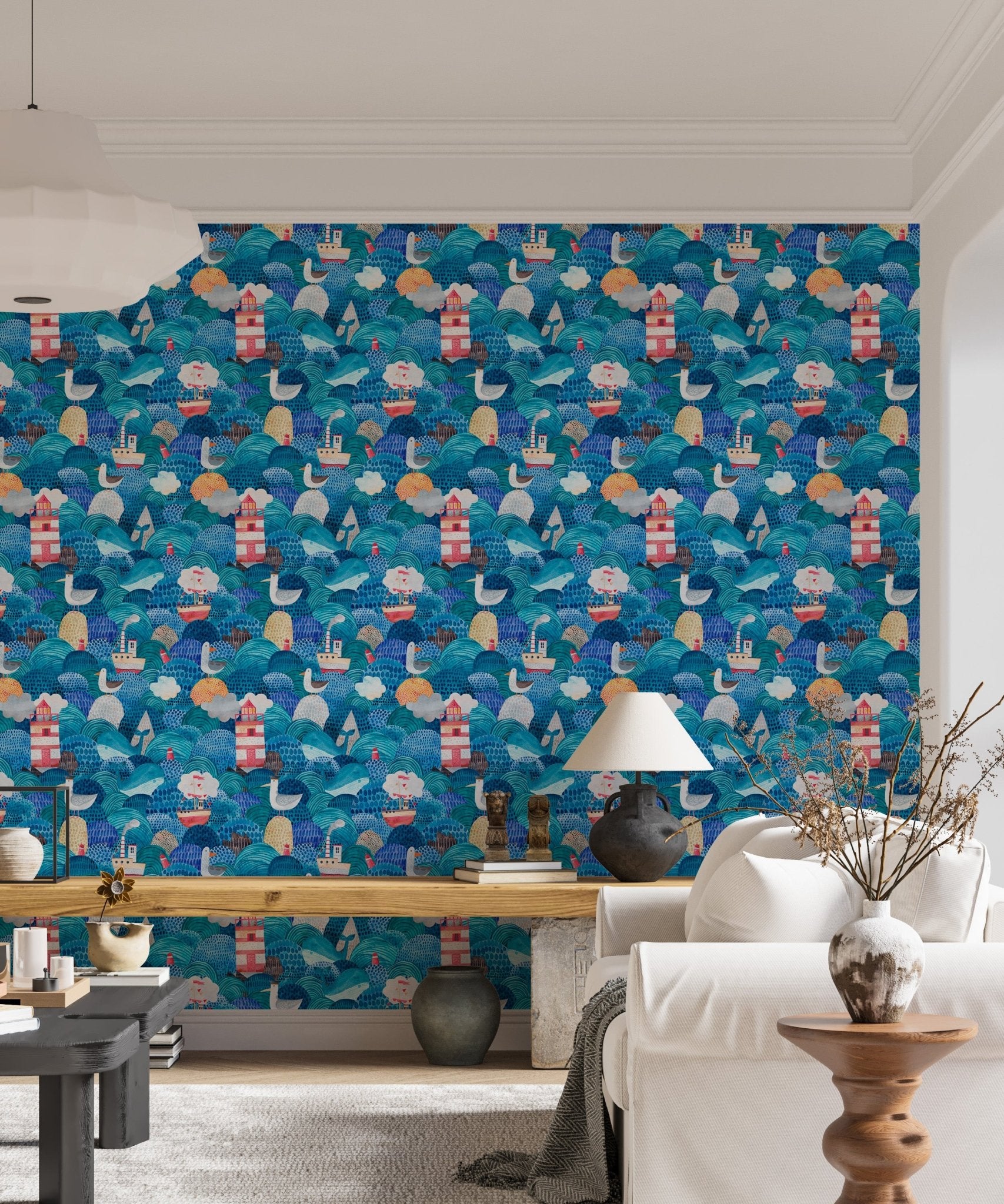 Living area with blue watercolor ship themed wallpaper.