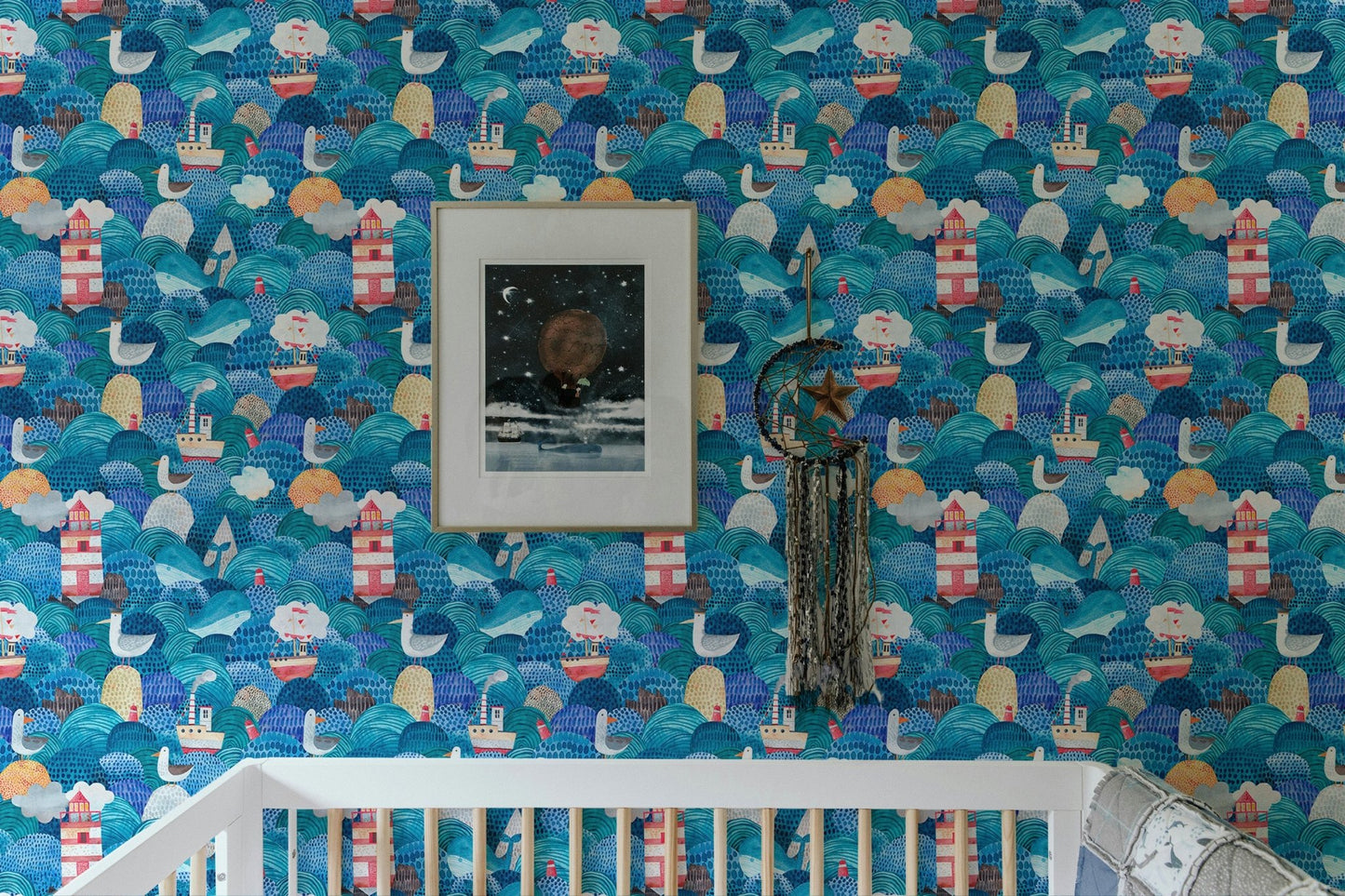 Nursery room crib placed in front of watercolor sea waves wallpaper.