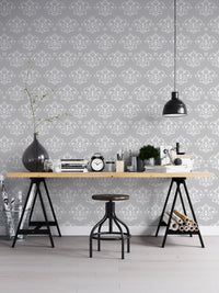 Vintage damask wallpaper in a home office with a black industrial desk.