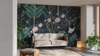 Dark background Green leaves Flower Wall mural behind a grey sofa in a living area.