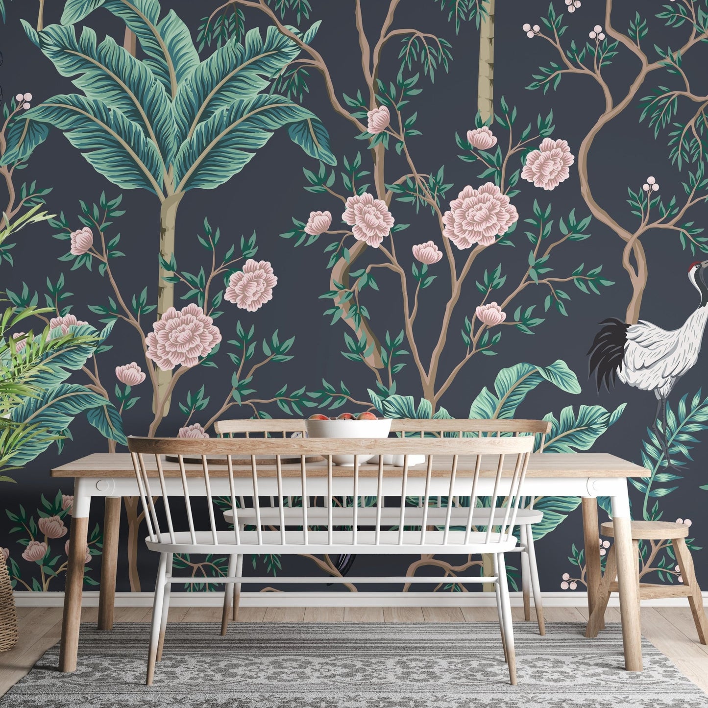 Botanical wall mural featuring teal leaves and pink blossoms behind a dining table.