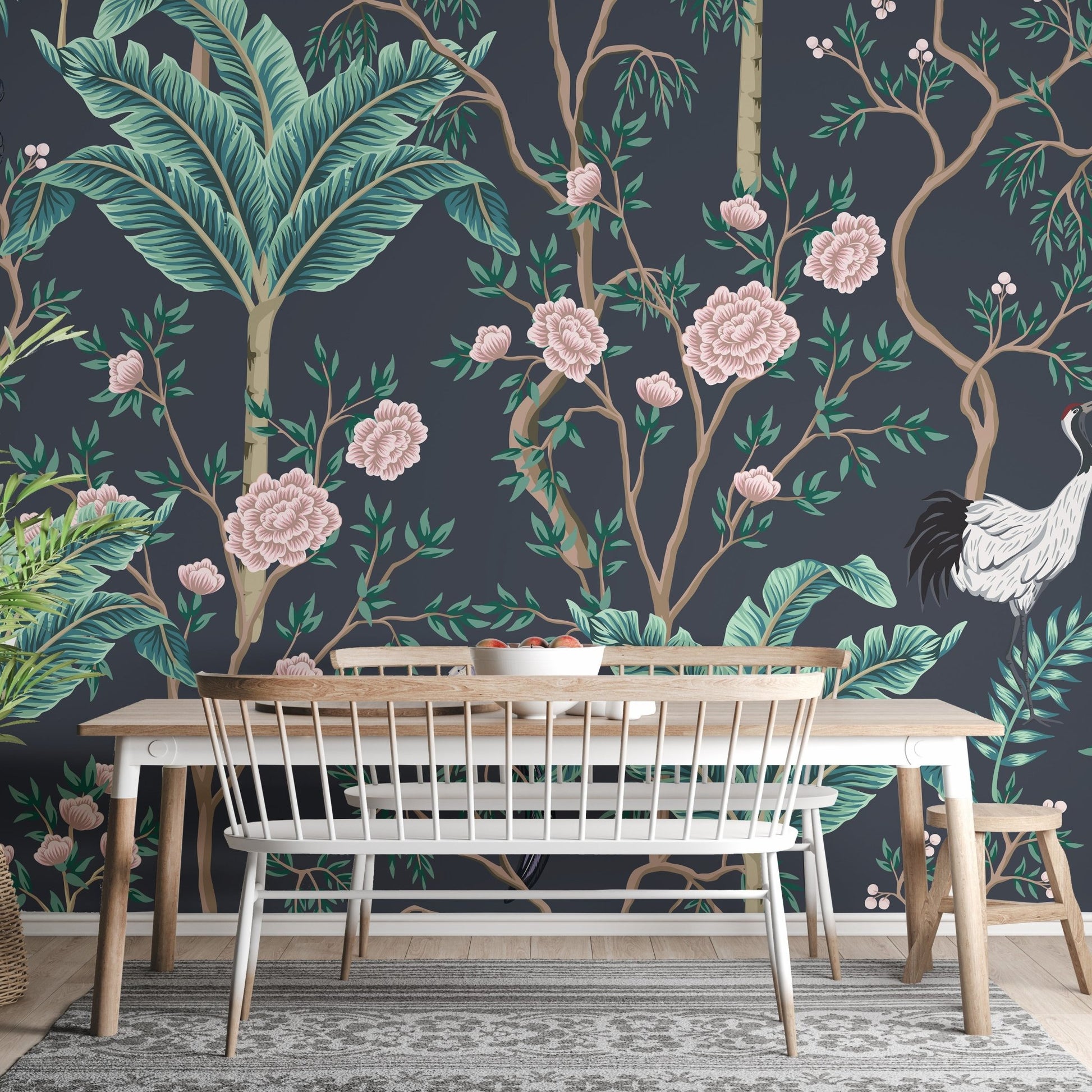 Botanical wall mural featuring teal leaves and pink blossoms behind a dining table.