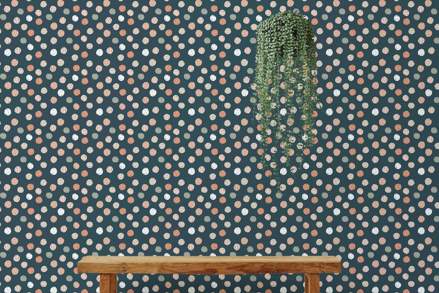 Minimalist wallpaper with irregular dots behind a wooden bench and hanging plant