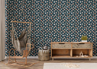 Textured dot wallpaper in a nursery with a hanging chair and wooden console