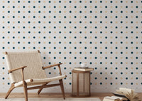 Geometric dot pattern wallpaper in a reading area with a wicker chair.