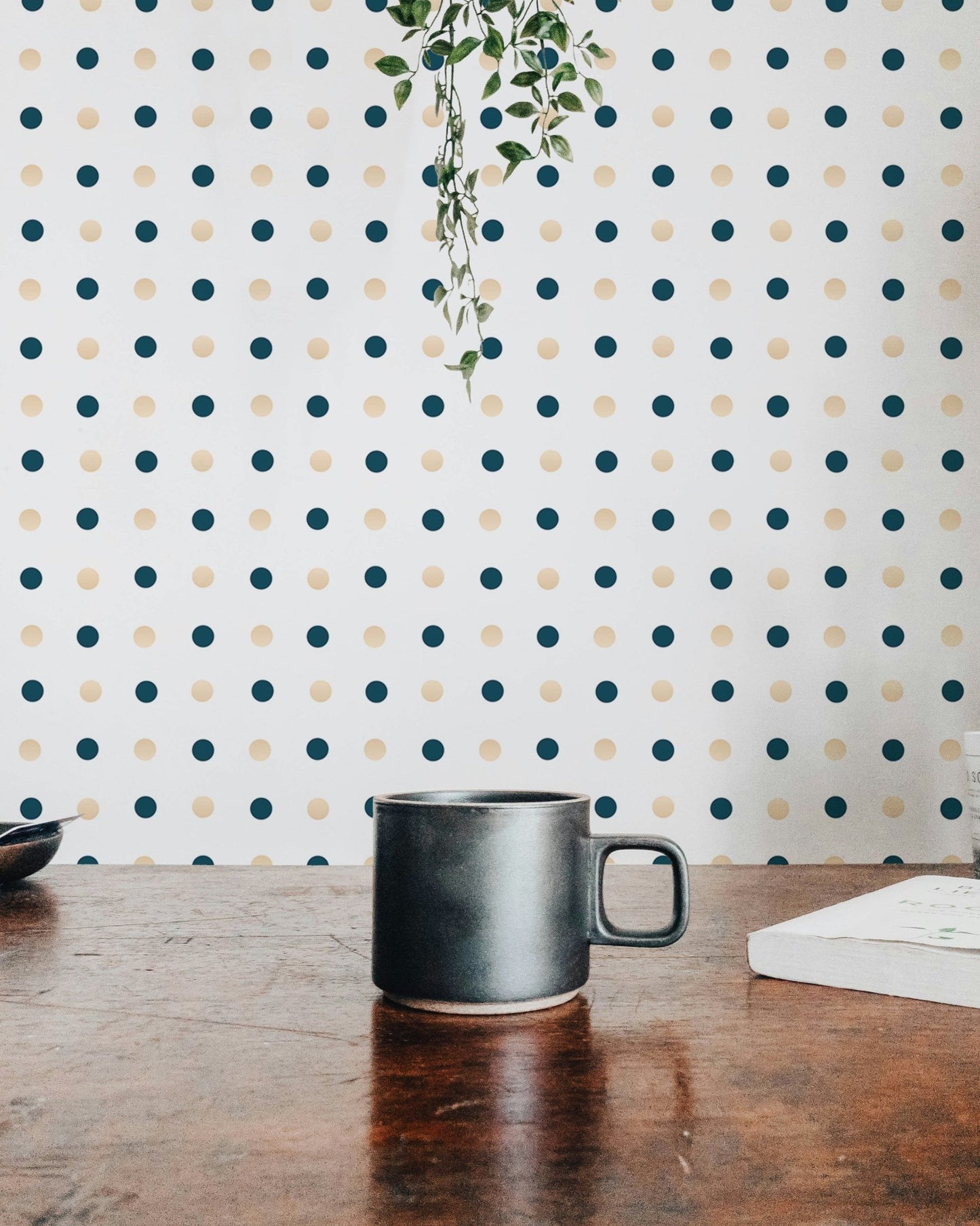 Dotted Patterned wallpaper on a dining room wall with a dark ceramic mug.