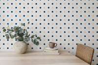Wallpaper with navy and gold circles behind a wooden dining table.