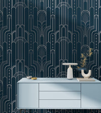 Art deco wallpaper with silver arches above a light blue modern cabinet.