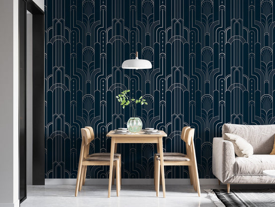 Dark blue wallpaper with symmetrical arches in a small dining area.
