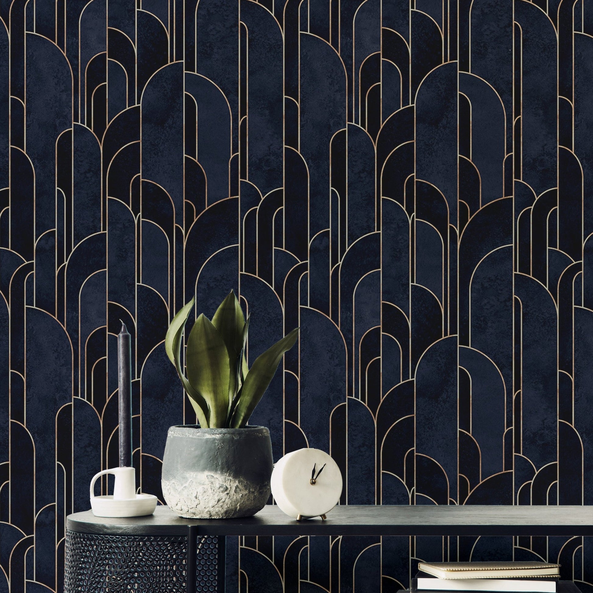 Sophisticated dark blue Deco adhesive wallpaper behind black marble table.