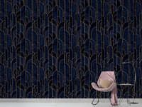 Navy blue geometric wallpaper in a minimalist room with a pink chair.