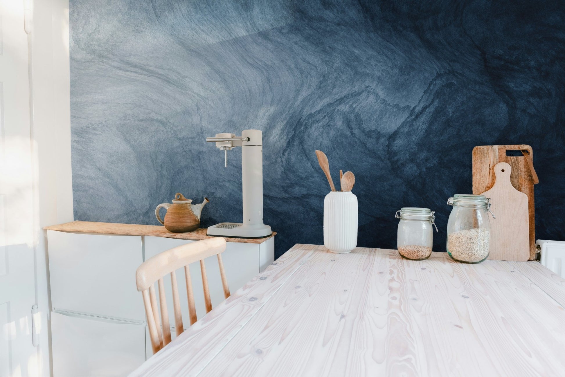 Fluid texture wallpaper in a bright kitchen and dining area.