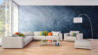 Blue fluid texture wallpaper behind a white sectional sofa in a living area.