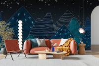 Orange sofa arrangement with a dark blue mountain wall mural.