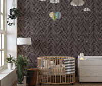 Dark brown brick wallpaper in a nursery room with a wooden crib and wall decor.