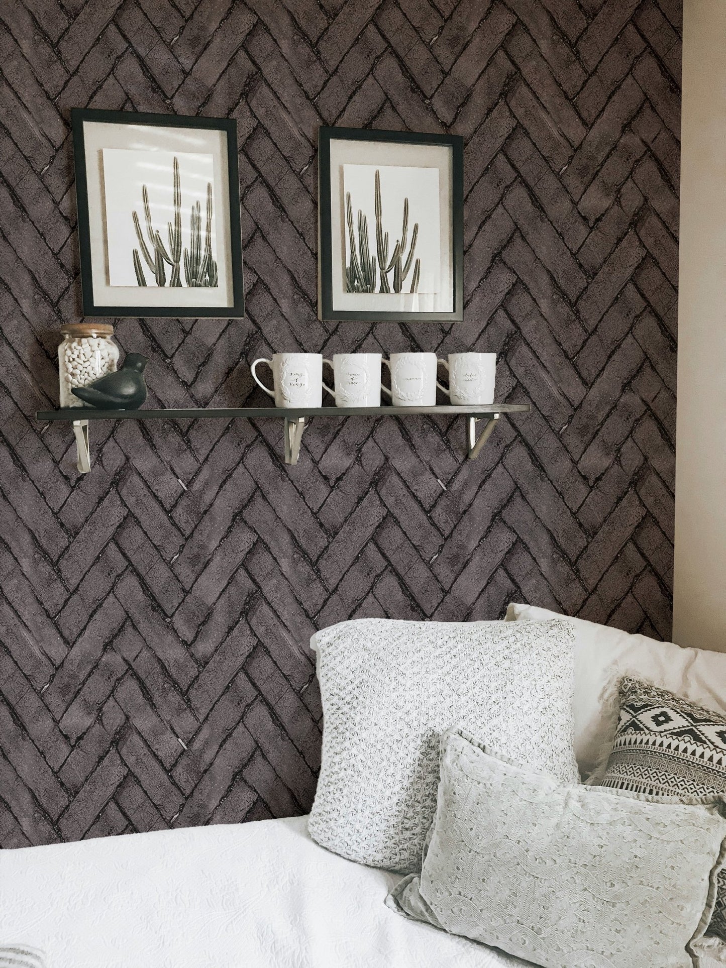 Textured dark brown brick wallpaper for a home office setup with floating shelves.