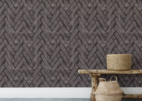 Horizontal dark brown brick pattern wallpaper behind a rustic wooden bench.